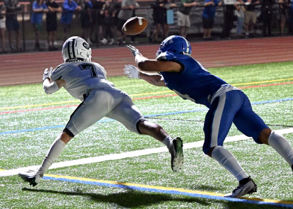 Walter Mayo of D-Y stretches out with Vincent Pinnetti of Mashpee closely defending. The first half pass fell short in the endzone.