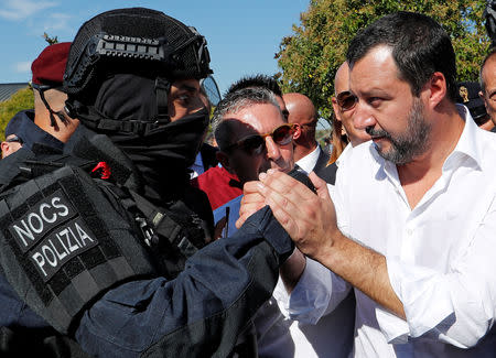 FILE PHOTO: Italian Deputy Prime Minister and Interior Minister Matteo Salvini shakes hands with a member of the state police SWAT team during a gathering to celebrate their anniversary in Rome, Italy, October 10, 2018. REUTERS/Remo Casilli/File Photo
