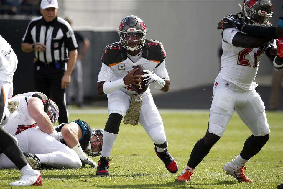 Tampa Bay Buccaneers quarterback Jameis Winston, center, scrambles from the pocket during the first half of an NFL football game against the Jacksonville Jaguars, Sunday, Dec. 1, 2019, in Jacksonville, Fla. (AP Photo/Stephen B. Morton)