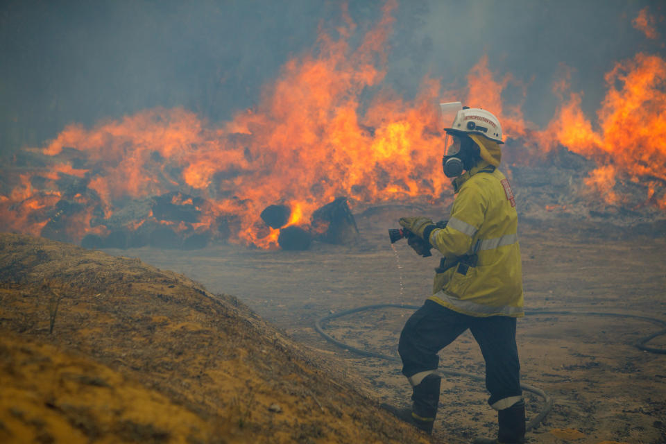 A firefighter is seen trying to extinguish a blaze. Source: AAP Image