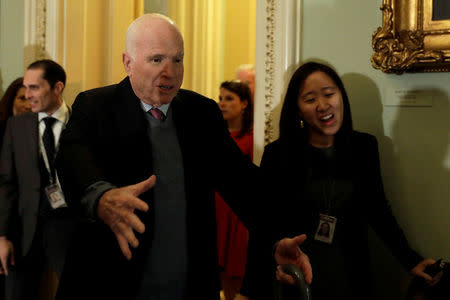 U.S. Senator John McCain (R-AZ) jokes with reporters before the party luncheon on Capitol Hill in Washington, U.S., November 14, 2017. REUTERS/Yuri Gripas