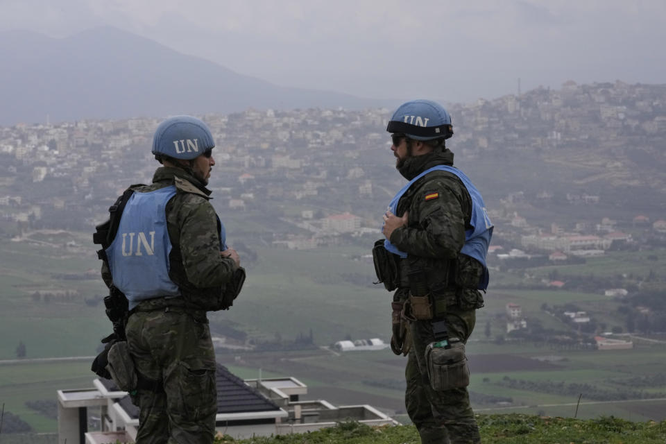 FILE - Spanish U.N. peacekeepers stand on a hill overlooking the Lebanese border villages with Israel in Marjayoun town on Wednesday, Jan. 10, 2024. The prospect of a full-scale war between Israel and Lebanon's Hezbollah militia terrifies people on both sides of the border, but some see it as an inevitable fallout from Israel's ongoing war against Hamas in Gaza, particularly as cease-fire negotiations have faltered. (AP Photo/Hussein Malla, File)