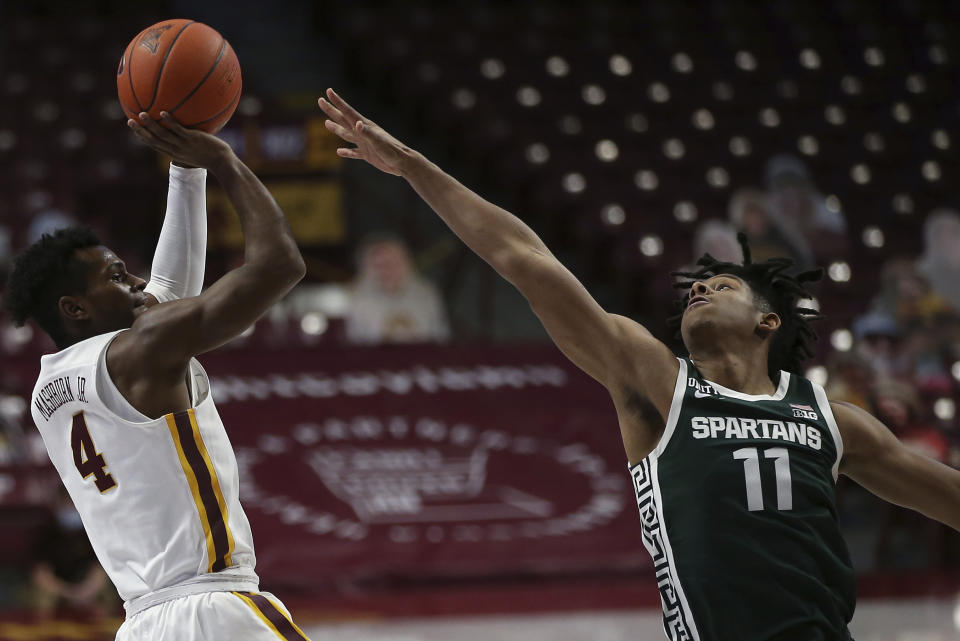 Minnesota's Jamal Mashburn Jr. (4) shoots as Michigan State's A.J. Hoggard (11) defends during the first half of an NCAA college basketball game Monday, Dec. 28, 2020, in Minneapolis. (AP Photo/Stacy Bengs)