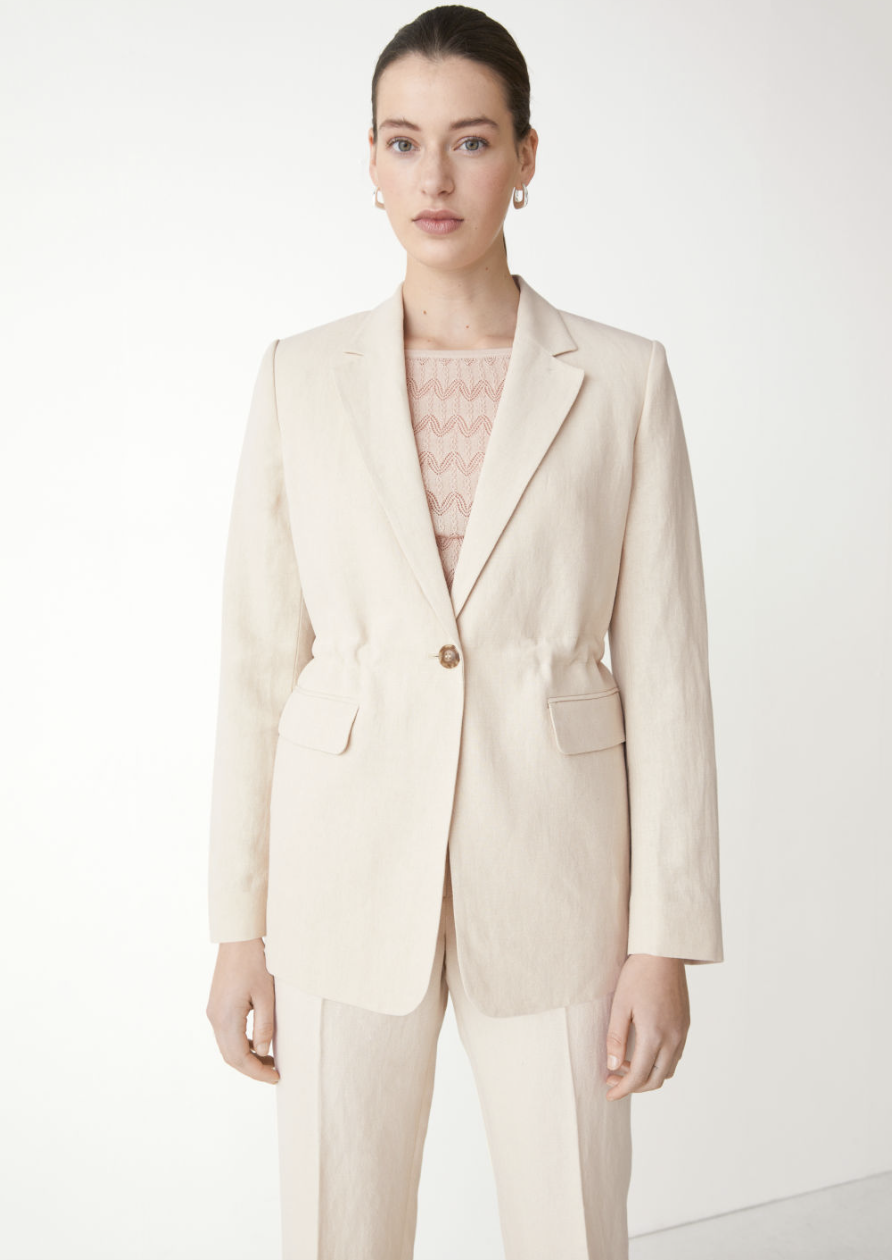 model in light beige pants and matching Silk Linen Blazer (Photo via & Other Stories)