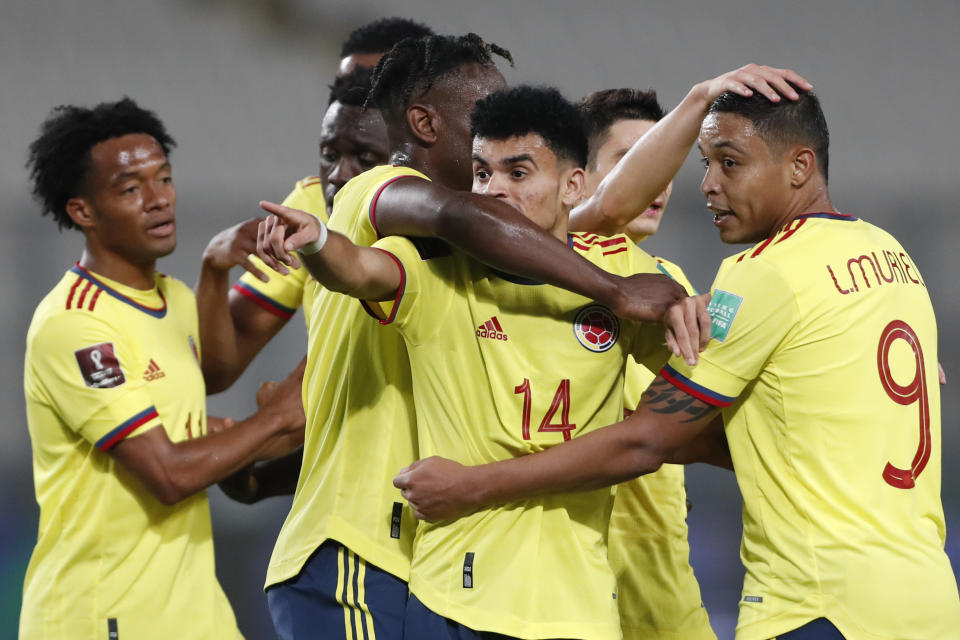 Colombia's Luis Diaz (14) celebrates scoring his side's third goal against Peru during a qualifying soccer match for the FIFA World Cup Qatar 2022 at the National stadium in Lima, Peru, Thursday, June 3, 2021. (Paolo Aguilar/Pool via AP)