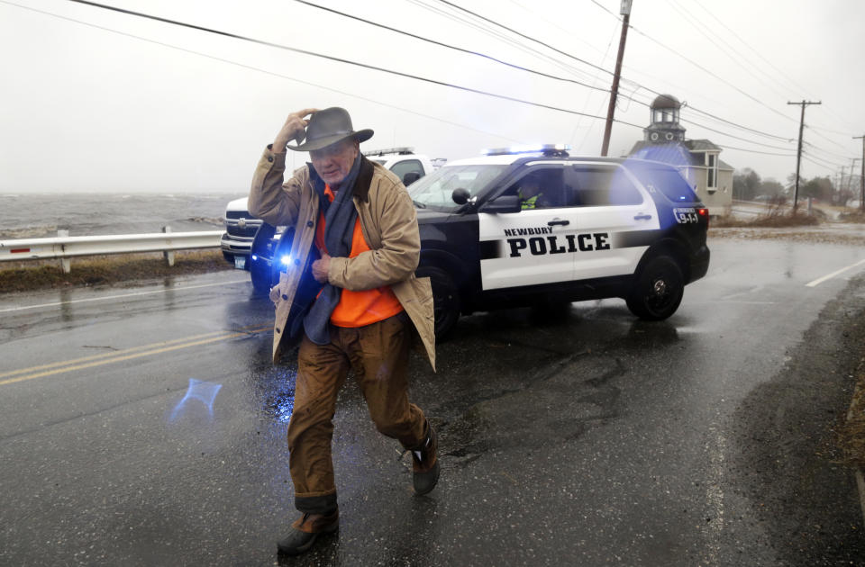 <p>A pedestrian walks away after being told by police that a flooded roadway towards Plum Island is closed Friday, March 2, 2018, in Newburyport, Mass., as a major nor’easter pounds the East Coast, packing heavy rain, intermittent snow and strong winds. The Eastern Seaboard is expected to be buffeted by wind gusts exceeding 50 mph, with possible hurricane-strength winds of 80 to 90 mph on Cape Cod. (Photo: Elise Amendola/AP) </p>