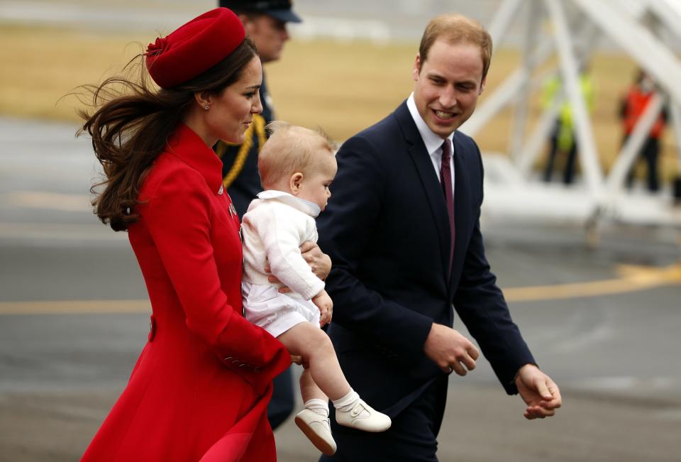 Britain's Prince William walks with his wife Catherine, Duchess of Cambridge, and their son Prince George after disembarking from their plane upon their arrival in Wellington April 7, 2014. The Prince and his wife Kate are undertaking a 19-day official visit to New Zealand and Australia with their son George. REUTERS/Phil Noble (NEW ZEALAND - Tags: ROYALS ENTERTAINMENT)