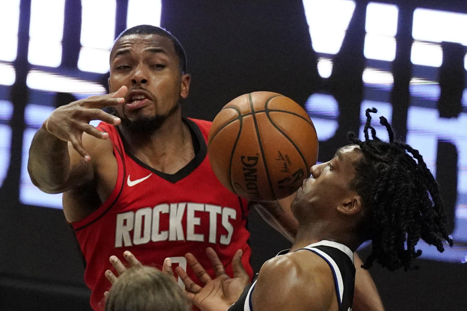 Los Angeles Clippers guard Terance Mann, right, loses control of the ball while under pressure from Houston Rockets forward Sterling Brown during the second half of an NBA basketball game Friday, April 9, 2021, in Los Angeles. The Clippers won 126-109. (AP Photo/Mark J. Terrill)