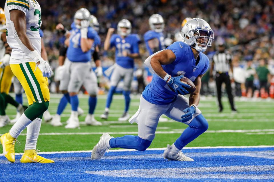 Lions wide receiver Amon-Ra St. Brown scores a touchdown during the first half of the Lions' 37-30 win over the Packers on Sunday, Jan. 9, 2022, at Ford Field.