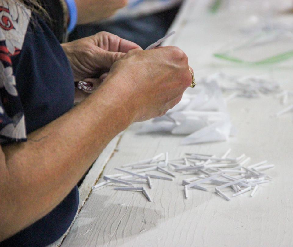 The Portuguese feast includes a bazaar where customers try their luck at winning prizes with twists of rolled paper, at the Great Feast of the Holy Ghost of New England on Thursday, Aug. 24, in Fall River.