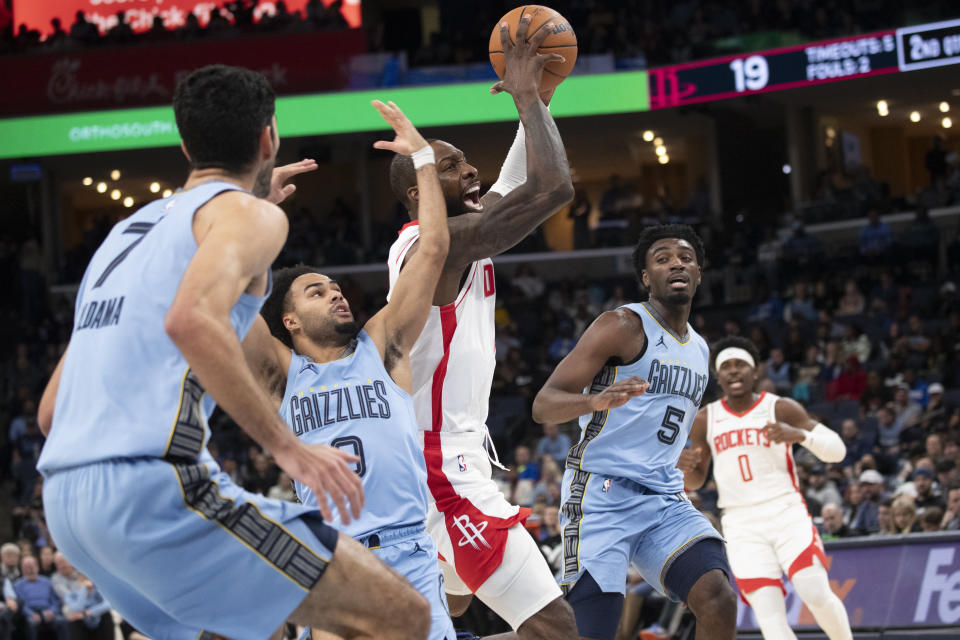 Houston Rockets forward Jeff Green, center, drives through the defense of Memphis Grizzlies forward Santi Aldama (7), guard Jacob Gilyard (0) and guard Vince Williams Jr. (5) during the first half of an NBA basketball game Friday, Dec. 15, 2023, in Memphis, Tenn. (AP Photo/Nikki Boertman)