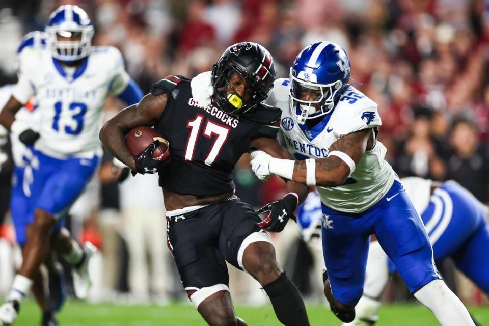 Kentucky linebacker Trevin Wallace (32) tackles South Carolina wide receiver Xavier Legette (17) during Saturday’s game at Williams-Brice Stadium.
