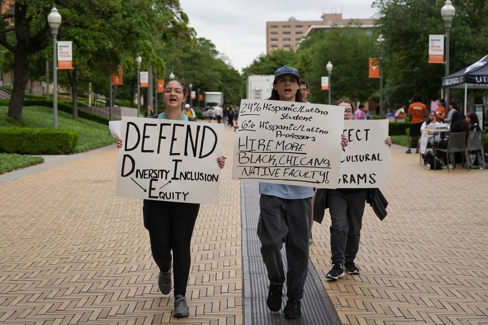 Ashley Awad and Jules Lattimore protest legislation prohibiting diversity, equity and inclusion efforts at the University of Texas last April. The Austin chapter of Students for a Democratic Society held the demonstration and advocated for more funding for multicultural programs and hiring more tenure-track faculty members of color.