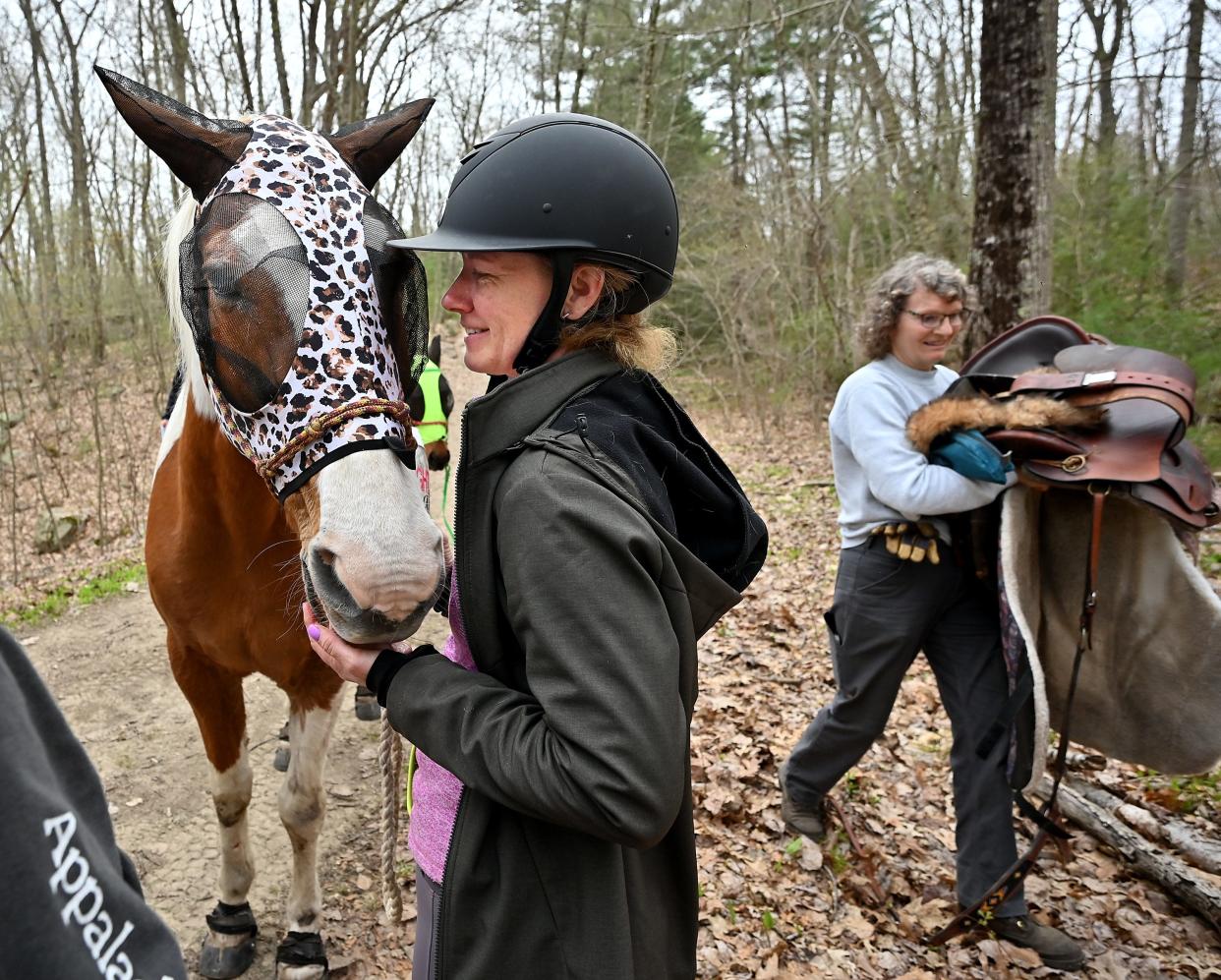 Sara DiPietro of Burrillville, R.I., and her 23-year-old horse, Hunter, Wednesday at Douglas State Forest after a trail accident.