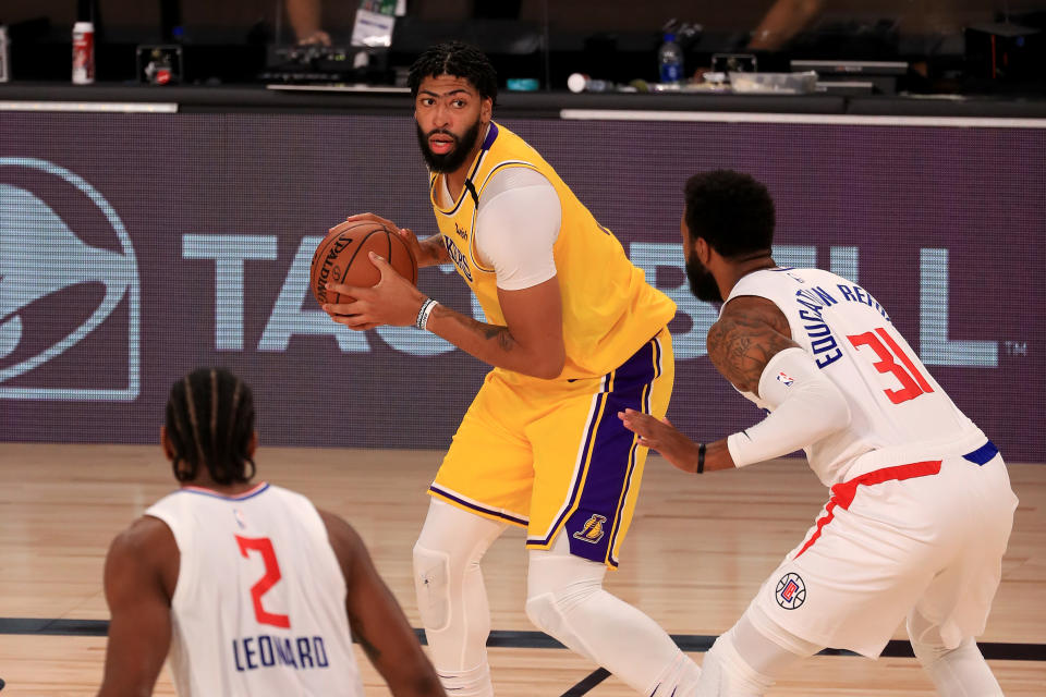 LAKE BUENA VISTA, FLORIDA - JULY 30: Anthony Davis #3 of the Los Angeles Lakers looks to pass against Marcus Morris Sr. #31 of the LA Clippers during the third quarter of the game at The Arena at ESPN Wide World Of Sports Complex on July 30, 2020 in Lake Buena Vista, Florida. NOTE TO USER: User expressly acknowledges and agrees that, by downloading and or using this photograph, User is consenting to the terms and conditions of the Getty Images License Agreement. (Photo by Mike Ehrmann/Getty Images)