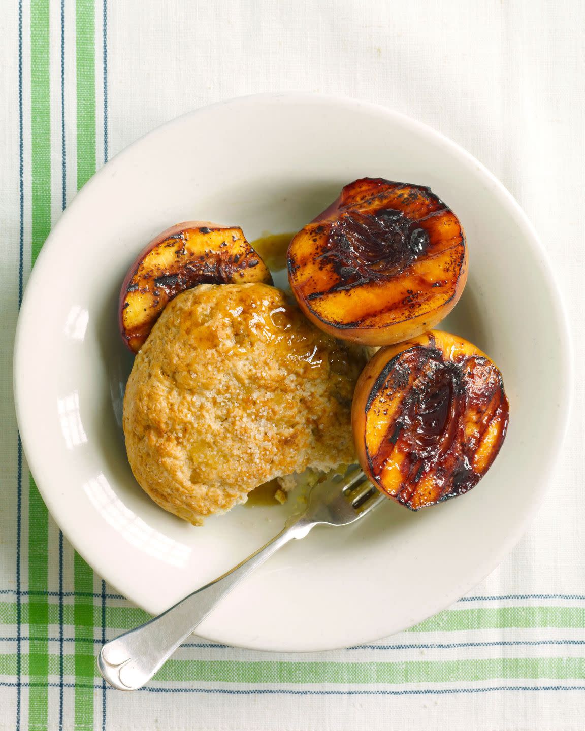 grilled peach cobbler on a plate with a fork