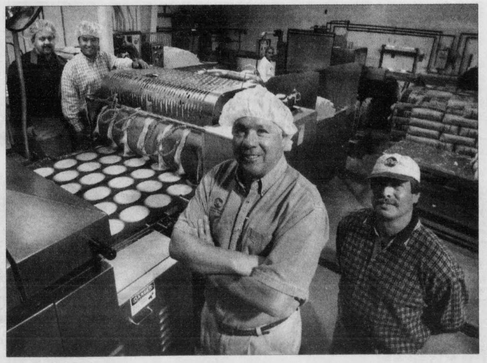 George Puentes, center, at the production facility for Don Pancho Authentic Mexican Foods in 2001.