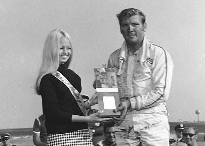 Richard Brickhouse collects the one and only winner's trophy of his NASCAR career, at Talladega in 1969.