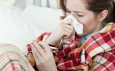 A woman lies in bed with the flu - Credit: Alamy 