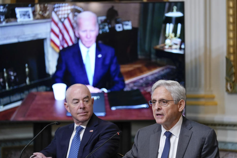 Attorney General Merrick Garland, right, speaks during the first meeting of the interagency Task Force on Reproductive Healthcare Access in the Indian Treaty Room in the Eisenhower Executive Office Building on the White House Campus in Washington, Wednesday, Aug. 3, 2022. Homeland Security Secretary Alejandro Mayorkas, left, and President Joe Biden, on screen, listen. (AP Photo/Susan Walsh)
