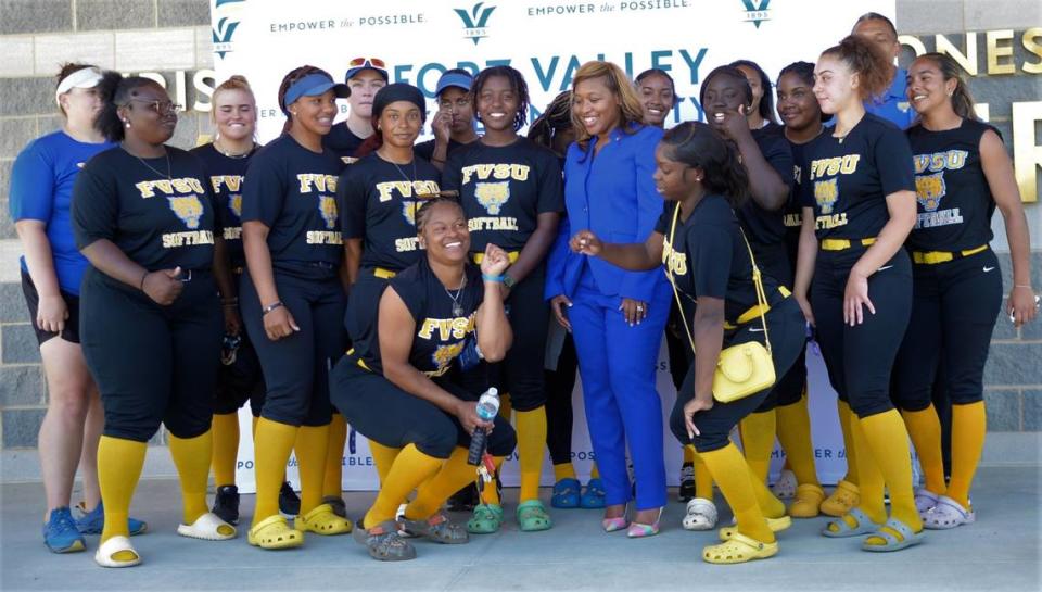 Students and coaches from the Fort Valley State softball team pose with athletic director Renae Myles Payne (center) at a press conference Thursday, March 23, 2023.