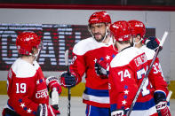 Washington Capitals left wing Alex Ovechkin (8), from Russia, is congratulated by center Nicklas Backstrom (19), from Sweden, defenseman John Carlson (74), and defenseman Radko Gudas (33), from Czech Republic, after scoring during the first period of an NHL hockey game against the New Jersey Devils, Thursday, Jan. 16, 2020, in Washington. (AP Photo/Al Drago)