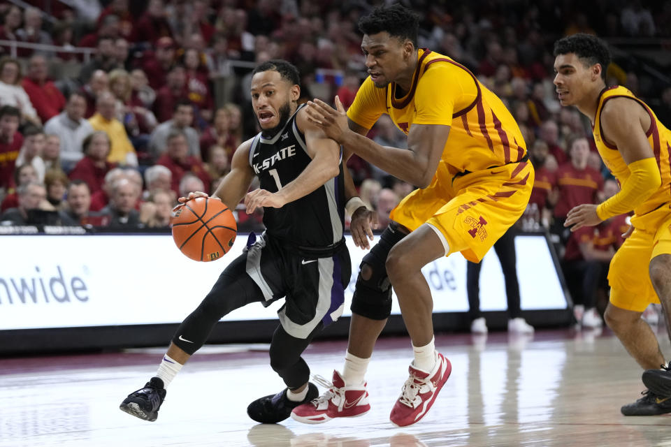 Kansas State guard Markquis Nowell (1) drives to the basket past Iowa State center Osun Osunniyi during the second half of an NCAA college basketball game, Tuesday, Jan. 24, 2023, in Ames, Iowa. (AP Photo/Charlie Neibergall)
