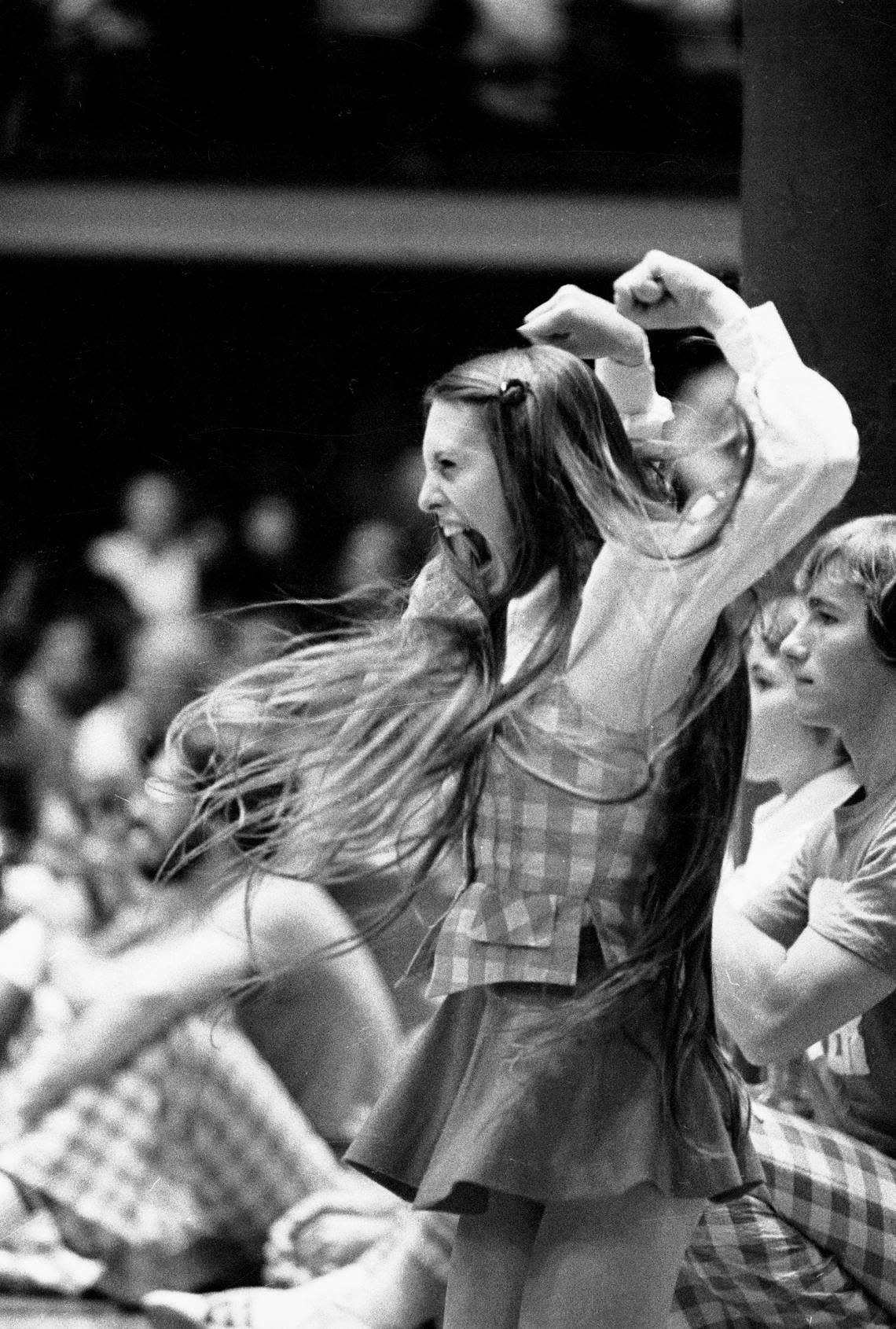 A Wolfpack cheerleader in action on the sidelines during a 1974 game.