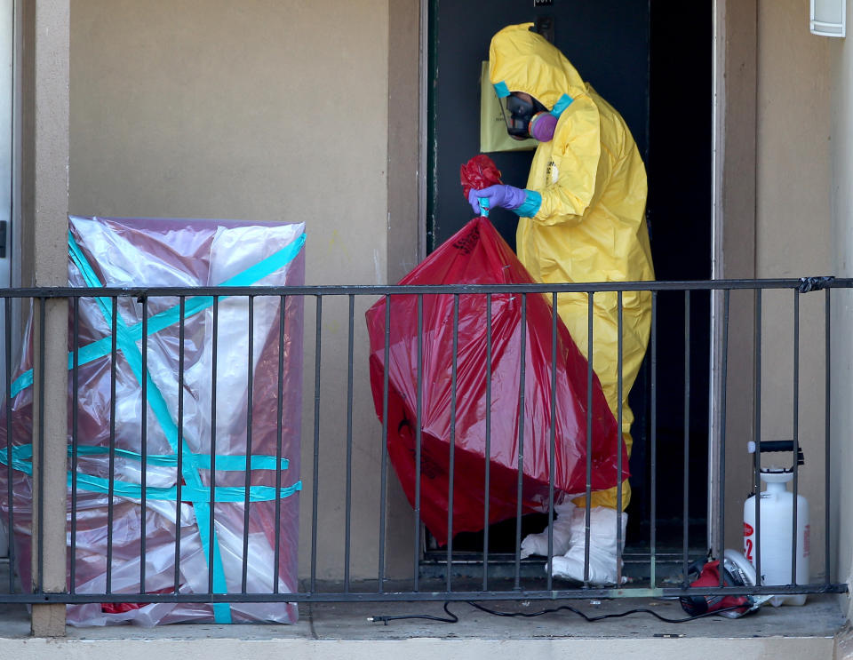 A cleaning crew removes items from the apartment where Ebola patient Thomas Eric Duncan was staying before being admitted to a hospital on October 6, 2014 in Dallas, Texas.