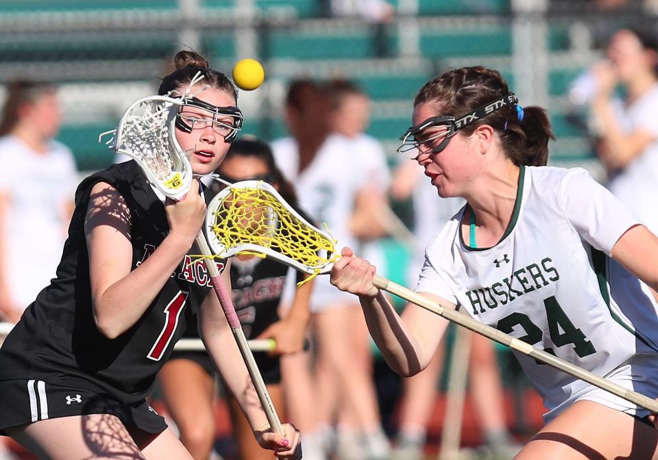 From left, NyackÕs Casey Cummings (1) and YorktownÕs Annie Cunneen (24) battle fro ball control during girls lacrosse action at Yorktown High School May 7, 2024. Nyack won the game 10-7.