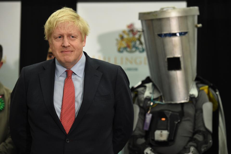 TOPSHOT - Britain's Prime Minister and Conservative leader Boris Johnson (L) waits with other candidates as the results are read out for the race to be MP for Uxbridge and Ruislip South at the count centre in Uxbridge, west London, on December 13, 2019 after votes were counted as part of the UK general election. - Prime Minister Boris Johnson's ruling party appeared on course for a sweeping victory in Thursday's snap election, an exit poll showed, paving the way for Britain to leave the EU next month after years of political deadlock. (Photo by Oli SCARFF / AFP) (Photo by OLI SCARFF/AFP via Getty Images)
