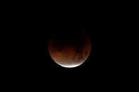 <p>A lunar eclipse is shown over the ocean in Oceanside, Calif., Jan. 31, 2018. (Photo: Mike Blake/Reutesr) </p>