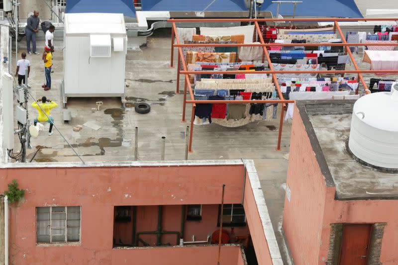 Residents work out on a rooftop during a nationwide lockdown for 21 days to try to contain the coronavirus disease (COVID-19) outbreak, in Braamfontein