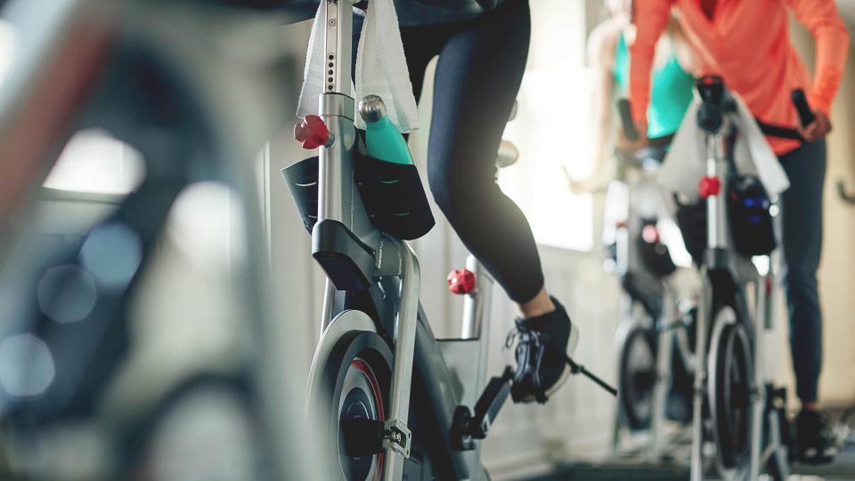 Cropped shot of women working out with exercise bikes in a exercising class at the gym.