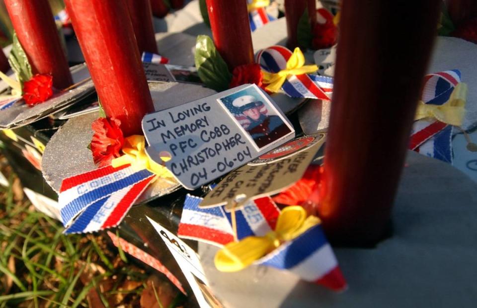 Candles at a candle light service on April 8, 2006, at Manasota Memorial Park bare the images and names of Pfc. Christopher Cobb, Spc. Justin Schmidt, Lance Cpl. Scott Dougherty and Sgt. Paul Mardis, all of whom were Manatee County men killed during military operations in 2004.