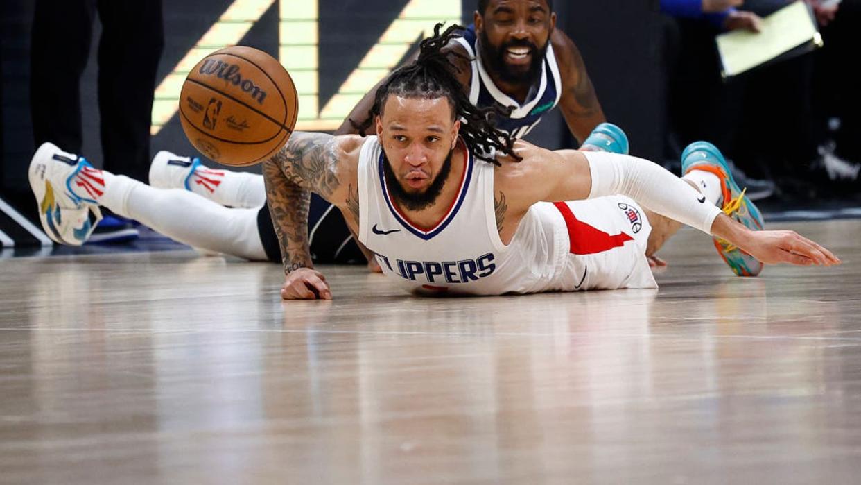 <div>Amir Coffey #7 of the LA Clippers dives for the loose ball against Kyrie Irving #11 of the Dallas Mavericks. (Photo by Ronald Martinez/Getty Images)</div> <strong>(Getty Images)</strong>