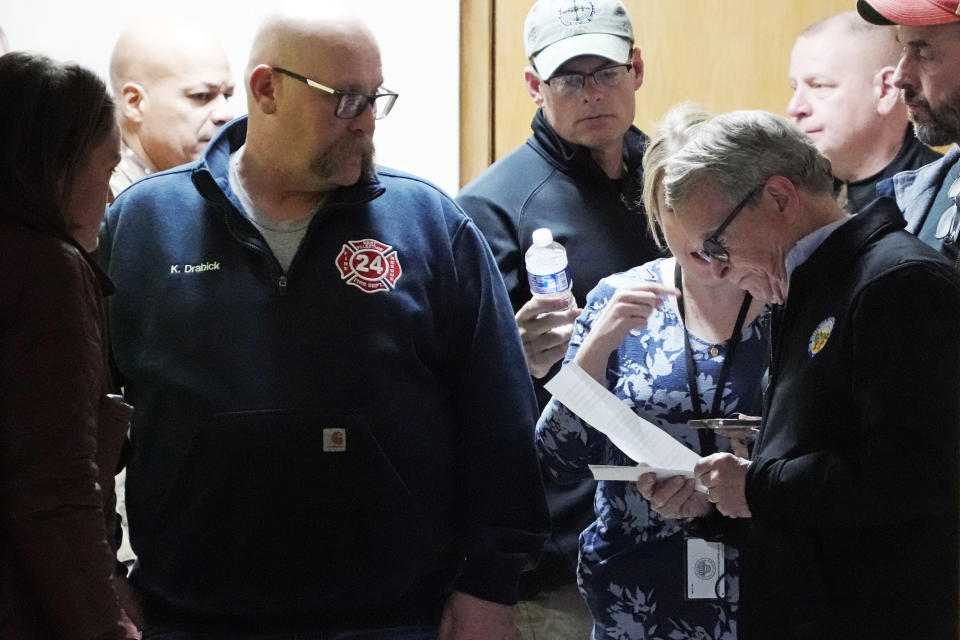 Ohio Governor Mike DeWine, right, prepares to meet with reporters after touring the Norfolk Southern train derailment site in East Palestine, Ohio, Monday, Feb. 6, 2023. (AP Photo/Gene J. Puskar)