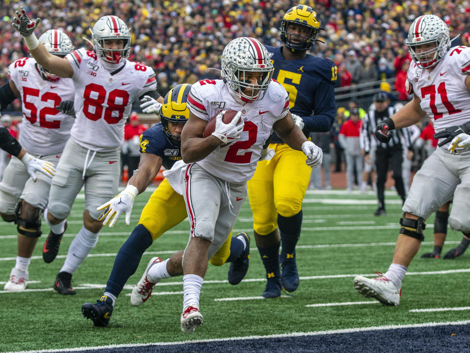 Ohio State running back J.K. Dobbins (2) scores a touchdown in the second quarter of an NCAA college football game against Michigan in Ann Arbor, Mich., Saturday, Nov. 30, 2019. (AP Photo/Tony Ding)