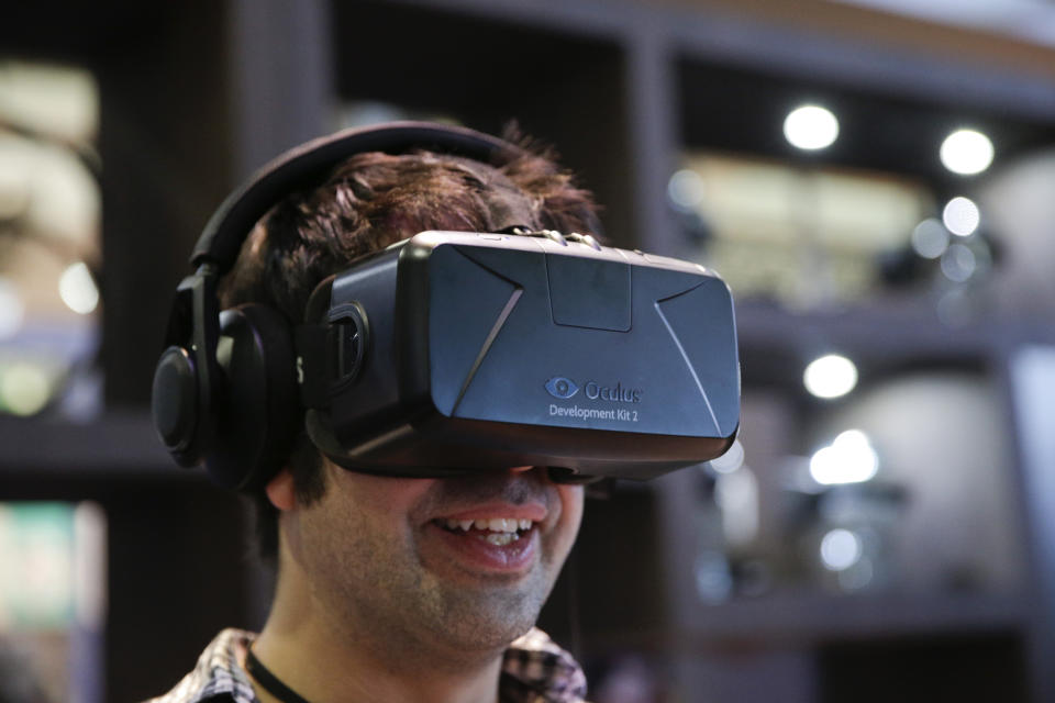 FILE - In this June 11, 2014 file photo, a man tries out the Oculus Rift virtual reality headset at the Oculus booth at the Electronic Entertainment Expo, in Los Angeles. From virtual reality headsets to the latest installments of 