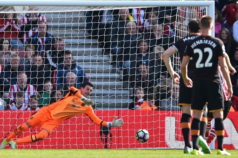 Hull City's Eldin Jakupovic dives to save the penalty kick taken by Southampton's Dusan Tadic during their match at St Mary's Stadium in Southampton, southern England on April 29, 2017