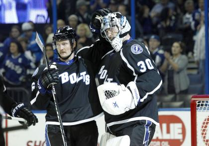 Nov 29, 2014; Tampa, FL, USA; Tampa Bay Lightning goalie Ben Bishop (30) and defenseman Anton Stralman (6) congratulate each other after they beat the Ottawa Senators at Amalie Arena. Tampa Bay Lightning defeated the Ottawa Senators 4-1. (Kim Klement-USA TODAY Sports)