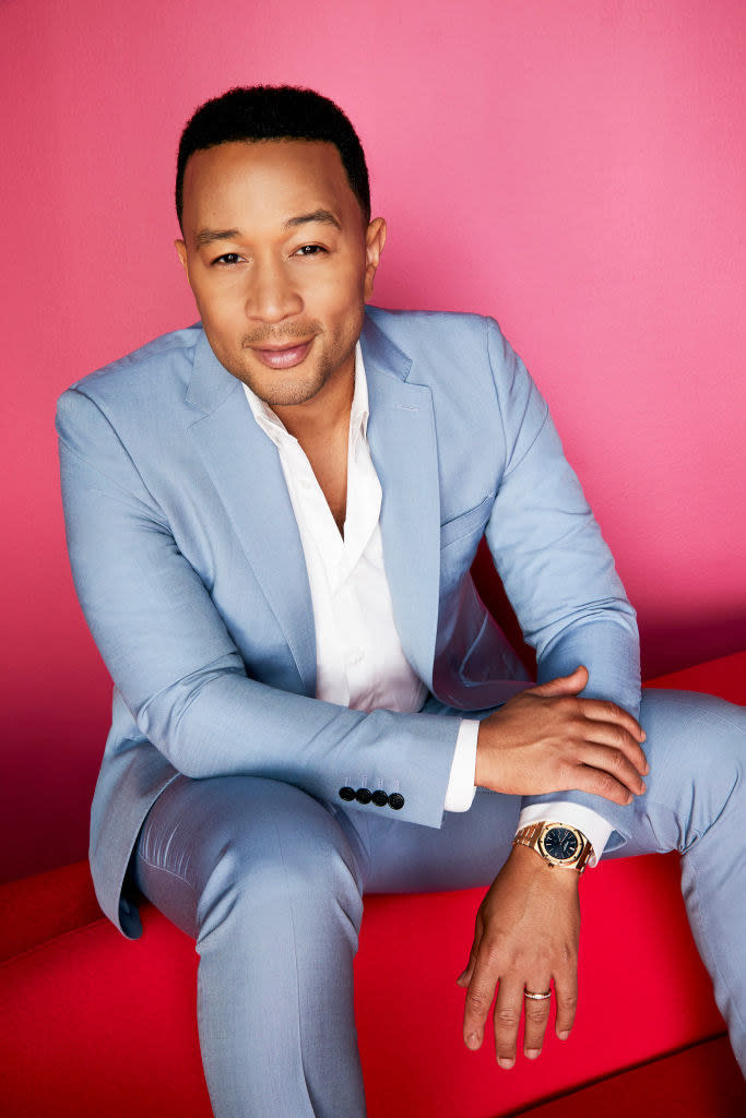 John sitting on a couch for a press pic for the voice