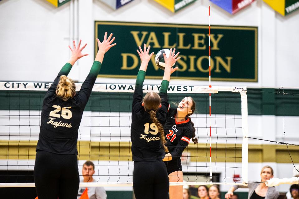 Iowa City High's Claire Ernst, right, goes up for an attack during volleyball match against Iowa City West.