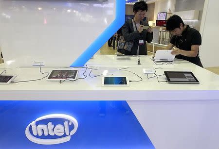 Visitors look at tablets at the Intel booth during the 2014 Computex exhibition at the TWTC Nangang exhibition hall in Taipei June 3, 2014. REUTERS/Pichi Chuang