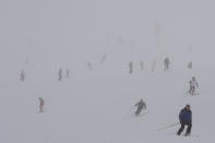 Tourists enjoy skiing, at Plan de Corones ski area, Italy South Tyrol, Saturday, Nov. 27, 2021. After nearly two years of being restricted to watching snow accumulate on distant mountains, Italian skiers are finally returning to the slopes that have been off limits since the first pandemic lockdown in March 2020. But just as the industry is poised to recover from a lost 2020-2021 season after an abrupt closure the previous year, a spike in cases in the Alpine province bordering Austria is underlining just how precarious the situation remains. (AP Photo/Luca Bruno)