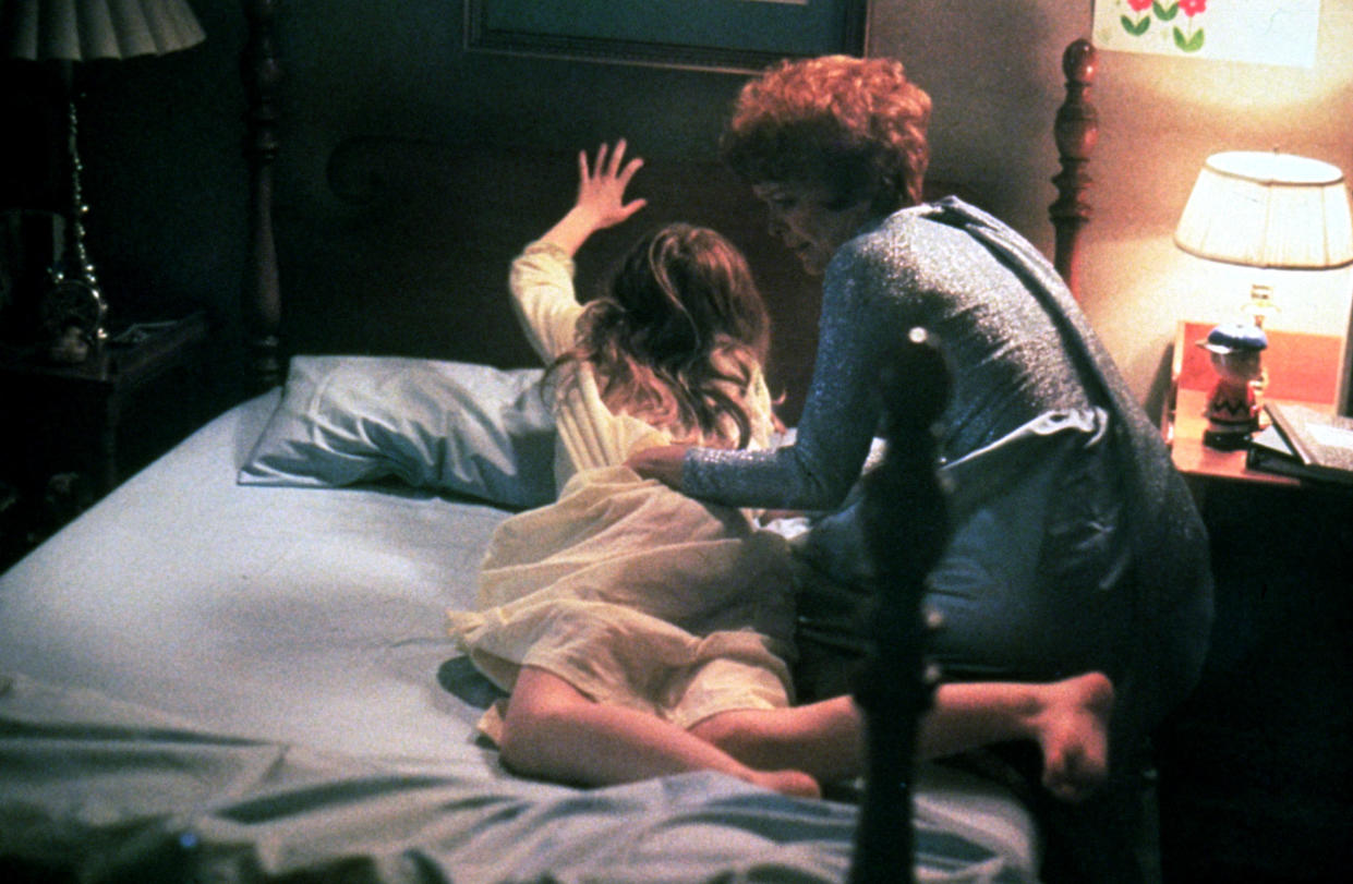 Ellen Burstyn literally wrestles with her devil-possessed daughter in the horror classic <em>The Exorcist.</em> (Photo: Courtesy of Everett Collection)