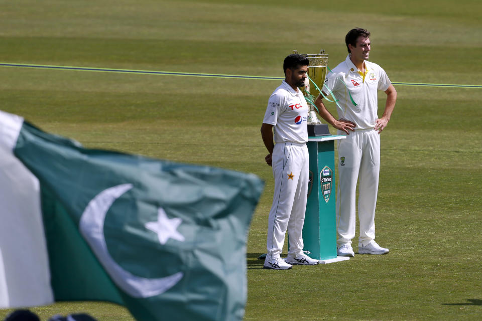 Pakistan's skipper Babar Azam, second right, and his Australian counterpart Pat Cummins pose for a photo with the test series trophy at the Pindi Stadium, in Rawalpindi, Pakistan, Wednesday, March 2, 2022. Pakistan and Australia cricket teams will play first test match on March 4. (AP Photo/Anjum Naveed)