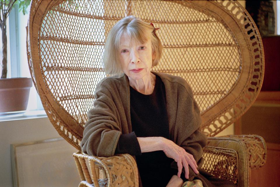 Didion seated on her rattan peacock chair in her Upper East side apartment.