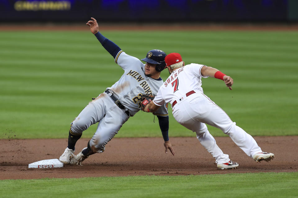 Milwaukee Brewers' Avisail Garcia, left, is tagged out by Cincinnati Reds' Eugenio Suarez while trying to steal second during the first inning of a baseball game in Cincinnati, Wednesday, Sept. 23, 2020. (AP Photo/Aaron Doster)