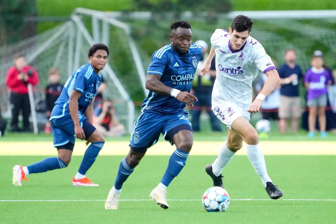 Sporting Kansas City forward Willy Agada, center, dribbles past Union Omaha midfielder Pedro Dolabella during Wednesday evening’s match at Caniglia Field in Omaha. Dylan Widger/USA TODAY Sports